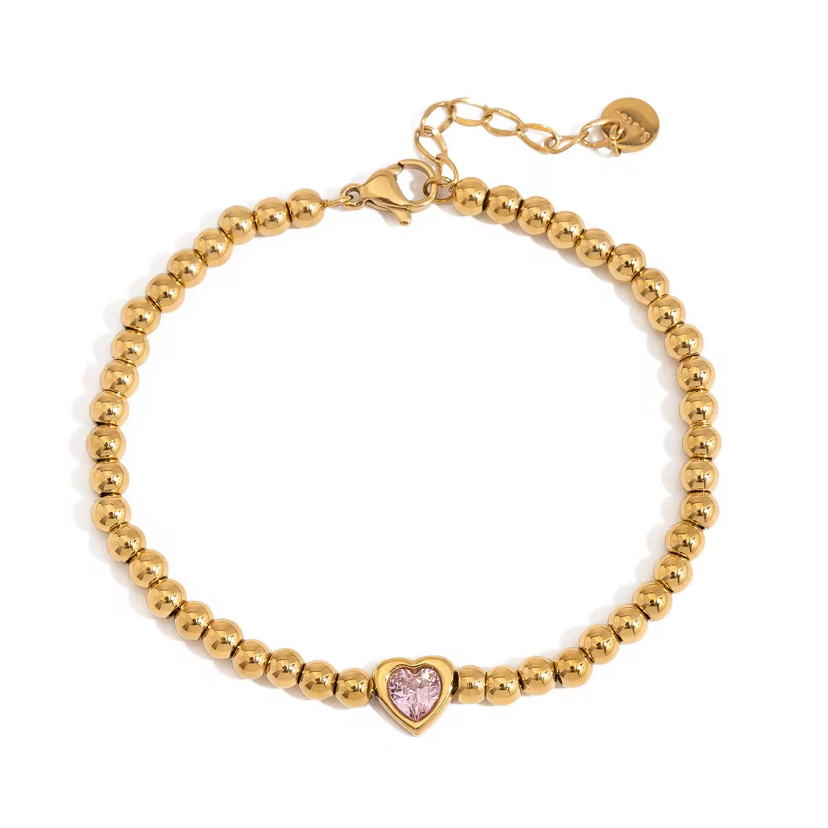 Gold beaded bracelet with a pink heart charm