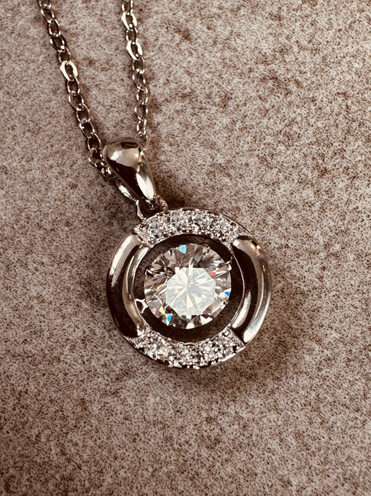 moissanite pendant necklace on a textured surface